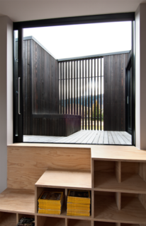 A clever combination bookshelf and staircase in the children’s bedroom leads to the interior "star-gazing" deck, which is invisible from the ground, and contains an open-air bathtub and a sauna. It is also accessible from an adjacent guest bedroom.<br><br>"The house is not huge but uses comparative spaces to create different experiences — it’s also about enjoying life and not being overly serious, hence these perceived ‘follies’ such as the deck. Those non-traditional elements have given the house a different flavor," says Cooke.