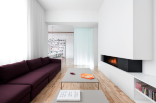 Interior designer Anne Sophie Goneau gave an apartment in a former factory a bright makeover. The minimal gas fireplace is from Ortal, acting as a focal point in the room, complete with integrated shelving.