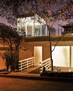 Dimster pierced the roof with a glass box topping the new central stair. To the right of the entrance is the transparent buffer between the facade and the kitchen, where an old courtyard once stood. "We wanted to keep the idea of the courtyard," says Dimster. "The frosted panels are a distinct feature of the facade."