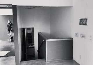 Dimster replaced and extended the original stair; the new version is in steel and glass and spans three floors.