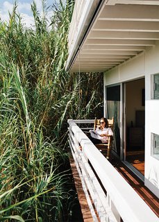 Marjorie takes to a Brumby rocking chair on the deck off the bedroom, which is privatized by a forest of bamboo.