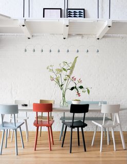 6 Simple Ways To Mix And Match Chairs At Your Dining Table Dwell Piet Hein Eek S Wooden Chairs Add A Touch Of Color To The Monochromatic Amsterdram Apartment