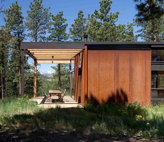 A Serene, Sustainable Home in Colorado - Photo 2 of 10 - Beyond the terrace, the backs of the Flatiron Peaks reveal themselves. Revegetation of the 35-acre property began immediately following construction of the home—a 2,500-square-foot structure that blends into its woodsy surroundings. <br><br>Photo by Ron Johnson.