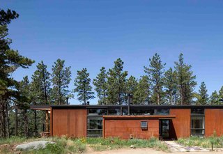 A Serene, Sustainable Home in Colorado - Photo 1 of 10 - A linear sequence of eight, 12-foot bays extends the length of the home from rear bedrooms and an office to the open kitchen and living room space. The modest form, a reflection of the owners' desire for simplicity, required few materials: wood, concrete, and steel.<br><br>Photo by Ron Johnson.