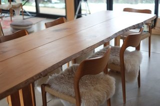 A Serene, Sustainable Home in Colorado - Photo 7 of 10 - For the dining room table, Hirsh and Volny collaborated with local company TCWoods, an urban sawmill that makes custom furniture and art from downed trees. Based on a classic George Nakashima design, the table is made from a maple tree that had been in front of Boulder High School.