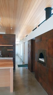 A Serene, Sustainable Home in Colorado - Photo 6 of 10 - A pizza oven and built-in storage spaces line a hallway, saving space. "6,000-square-foot houses for single families don't make sense ecologically—or in my opinion, functionally," says Hirsh. "The house is a nice size for our life—plenty large, but not unwieldy."<br><br>Photo by Ron Johnson.