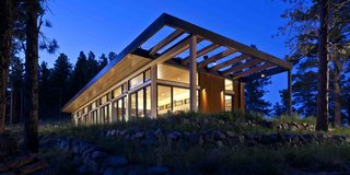 A Serene, Sustainable Home in Colorado - Photo 10 of 10 - Set amongst the trees, with its simple form and earthy adherence to wood, the home fits in well. "Veronica and I walked the land for many months before we decided where to put the house," says Hirsh. "We had picnics there. We sat looking east. We sat looking west. We sat looking south. The site felt wonderful."<br>Photo by Ron Johnson.