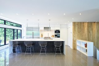 6 Marble Alternatives For Your Kitchen Worktops - Photo 7 of 9 - The kitchen features a wide Corian countertop and Bertoia stools. The polished ceramic flooring is from Céramique Décor in Québec.