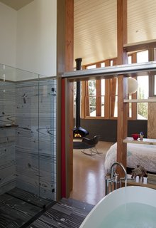 A new bathroom is just off the master bedroom. The plywood effect of much of the new interior is picked up in the gray floor and walls.