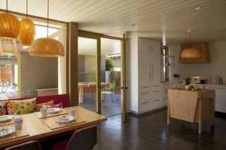 In the kitchen and dining room the booth and and table were both designed by the owners and fabricated by Custom Interior Design by Hugh Fitzpatrick. The throw pillows are from the product design arm of Rios Clementi Hale Studios, notNeutral.