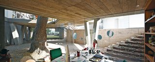 A Modern Concrete Home in Peru - Photo 2 of 13 - For a family in Lima, a team from local firm 51-1 Arquitectos built Casa Serpiente, which meanders around 25 existing trees. Husband Irzio’s study is among the few ground-level rooms in the 4,300-square-foot house.