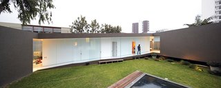 A Modern Concrete Home in Peru - Photo 5 of 13 - At once part of the city and protected from it, the house benefits from plenty of open space and light and creates its own courtyard enclosure.