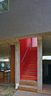 A Modern Concrete Home in Peru - Photo 13 of 13 - Given Lima’s dry climate, the architects were able to introduce clever indoor-outdoor gestures such as an open stairwell, and semicovered walkways that allow the trees to provide cover.