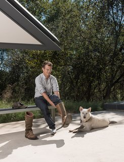 Home owner Chris Brown and his beloved dog Katsu get ready to take Dave on a tour of the Edgeland House land.