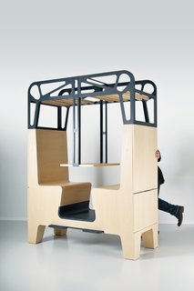 The wood-and-steel dining environment features two facing banquettes with hollow backs that house storage.
