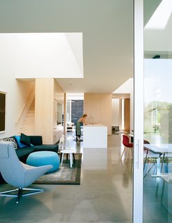 The kitchen contains an island countertop made of Corian in Glacier White.