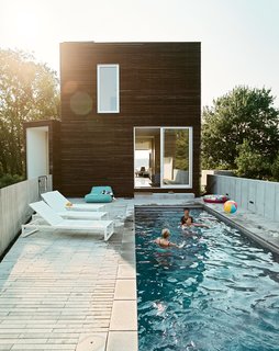 The east-facing pool terrace is outfitted with a series of Eos lounge chairs (and plenty of inflatable swim toys).