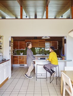 Louise Jenkins, left, chats with her daughter, Freya, who sits on a powder-coated Slatted bar stool by Jasper Morrison manufactured in Lancashire.