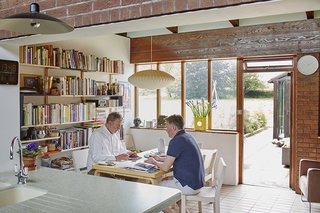 In the eat-in portion of the kitchen, a George Nelson Bubble Lamp hangs above an Artek table and chairs by Alvar Aalto.