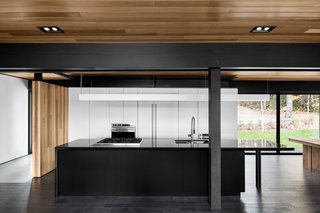 The kitchen’s black countertops were cut from Nero Assoluto granite. The sink and faucet are from Quebec-based company Rubi. Appliances are from Wolf.