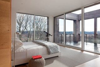 12 Striking Examples of Clerestory Windows in Modern Homes - Photo 7 of 12 - Ciavarra used floor-to-ceiling glass for the master bedroom, which leads onto a deck. "We wanted a place that just drew us up like a magnet," says Sophie about creating her dream home. "The house's design, comfort, and style certainly achieves that." 