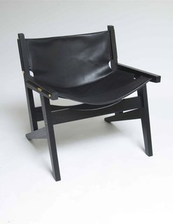 For a sleeker look, opt for the Peninsula chair in black. The whole chair is kept together by eight brass screws.