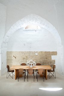 Modern Meets Ancient in a Renovated Italian Vacation Home - Photo 1 of 8 - Ludovica Serafini and Roberto Palomba, who work as Ludovica+Roberto Palomba, commissioned a dining table of their own design from Exteta and paired it with Abanica chairs by Oscar Tusquets for Driade. The ceramic centerpiece is by Emilia Palomba, Roberto’s aunt.