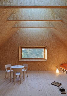Glulam beams keep the interior column free and enable a large skylight that runs the length of the roof.