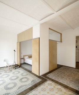 12 Creative Ways to Use Tile in Your Home - Photo 3 of 12 - This renovated apartment in Barcelona plays with subtle color contrasts, such as the chromatic tile mosaics and the blond wood used for sliding doors and benches.