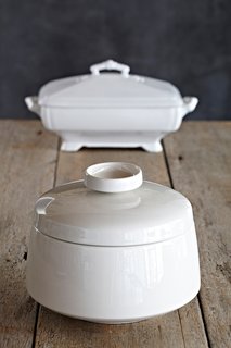 "Since the late 1600s, the tureen has held an important place on the table. To quote Alice in Wonderland, 'Beautiful soup, so rich, and green/Waiting in a hot tureen.' A century apart, these two white tureens, one in the Eva Zeisal style and the other an English classic from the 19th century, are ready set to serve green beans, pilaf, or a massive amount of candy."