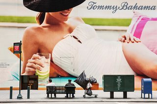 New York City ad and people resting on a bench in Natan Dvir's photography series Coming Soon.