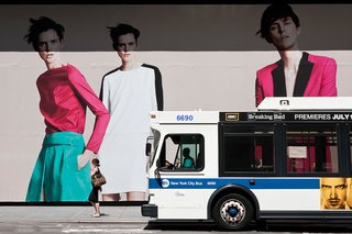 New York City ad and passing bus.