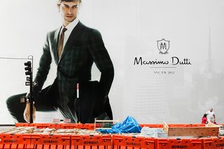 New York City ad and tourist looking up at model.