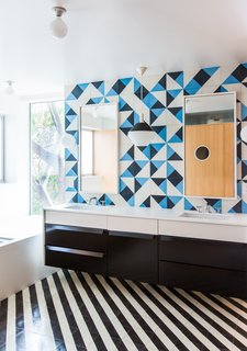 12 Creative Ways to Use Tile in Your Home - Photo 2 of 12 - The vanity countertop is Corian's Glacier White. The sconces are Glo-Ball designs by Jasper Morrison for Flos.