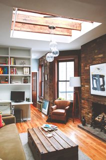 The best way to make a small space work is to find the hidden gems. The high ceilings, exposed brick and ridiculous skylight in this Chelsea one-bedroom gave us a pretty good foundation to go mountain-man modern. Photo by Chellise Michael Photography.