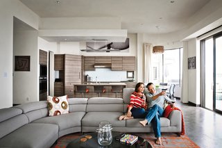 Bryan Cranston and his wife, Robin Dearden, relax on a Lagune sofa by Roche Bobois. The couple’s home occupies a beachfront site that they’ve owned for several years. The original structure, affectionately dubbed the "love shack" was born as 1940s-era military housing that in subsequent decades became an uneven hodgepodge that defied local permits and was slowly sinking into the sand.