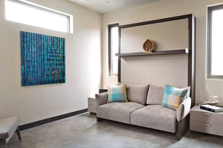 In a bedroom that’s used for guests, Robin demonstrates a foldable Murphy bed system, the Nuovoliola ’10 from Clei/Resource Furniture. The artwork, Orange Fish, is by Pablo Campos.