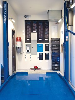 In the garage, a collection of smart-home technology is on display alongside a Bendpak Auto Lift, which builder Bryan Henson calls "an integral part of the house’s design: With the lift in place we met the county’s requirements for two covered parking spaces in a narrower garage bay. This freed up nearly 400 square feet of precious floor area on the other side of the house to accommodate both a mechanical room and a media room on the first floor."<br><br>Other mechanisms include a Broan whole house vacuum system that keeps the indoor air free of dust and allergens; a Lutron HomeWorks system that controls lighting and shades; an ELAN g! home system that controls irrigation, lighting, and security; and an AM House home-entertainment rack.