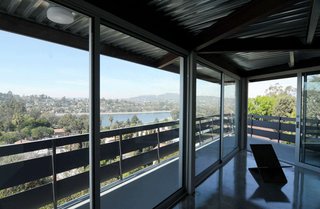 Located at the top of a hill, the house rises above the Silver Lake Reservoir, which can be seen from the living room upstairs.