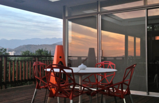 The deck of H House, which has incredible views, includes chairs by Konstantin Grcic.