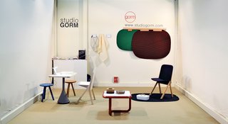 Studio GormMinimalist plastic-and-wood Judd coffee table and Scene carpet, whose abstract shapes recall American highway landscapes seen from a car window.