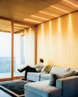 This Modern Cabin Is the Ideal HQ For a Family in Alaska - Photo 5 of 19 - The living room features a sofa by Dellarobbia.