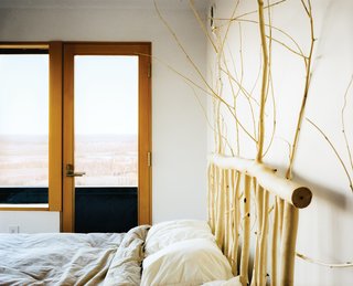 This Modern Cabin Is the Ideal HQ For a Family in Alaska - Photo 9 of 19 - Buser designed and made the headboard in the master bedroom from local aspens.