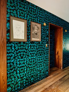 The once public hallway between the two apartments now boasts a bold wallpaper by Kravitz Design for Flavor Paper.