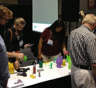Recap: 3D Printing Demo by Cubify - Photo 2 of 3 - Dwell on Design visitors inspect objects printed on the Cube, a 3D printer.