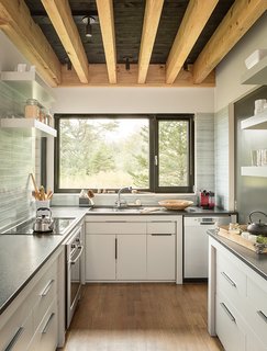 Cambrian black granite countertops were installed in the kitchen. "One of the favorite things I have to do in the kitchen is wash dishes, just because it’s such a delightful view out the window," Bullitt says.