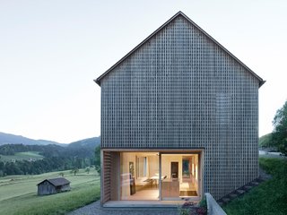 A Simple Gabled House Features an Intricate Latticework Shell - Photo 1 of 10 - The lattice shell was hewn from silver fir sourced from a nearby forest. Eternit shingles clad the roof.