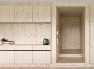 A Simple Gabled House Features an Intricate Latticework Shell - Photo 4 of 10 - Built-in shelving crafted by local carpenters distinguish the living area from the service zone, where appliances and utilities are stored. "Because of the integrated shelving, no additional furniture is needed for storage," Matt says.