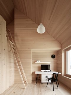 A Simple Gabled House Features an Intricate Latticework Shell - Photo 8 of 10 - Spruce wood also lines the floor, walls, and ceiling in the bedrooms. The residents must climb a ladder to access the loft above.