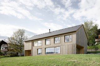 A Simple Gabled House Features an Intricate Latticework Shell - Photo 10 of 10 - The house's simple gable form helps the house blend in with its neighbors.